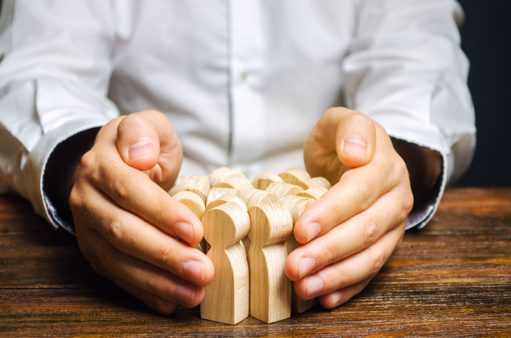 A person collecting a bunch of human-shaped wooden figures, representing Usenet article retention.