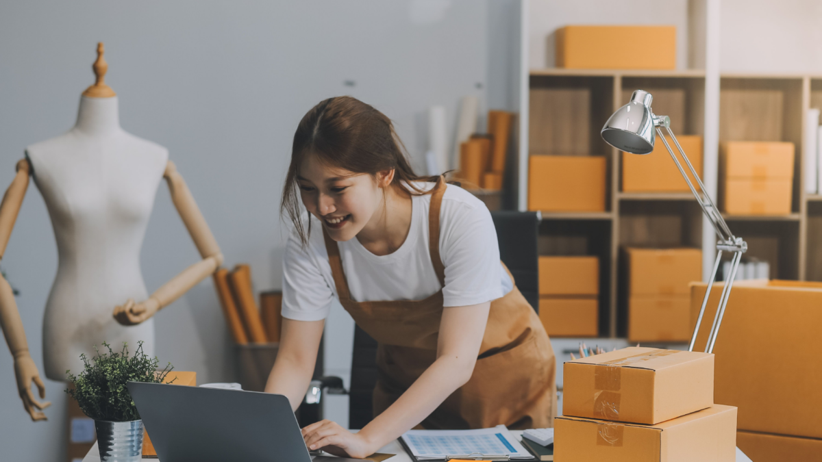 A woman in brown overalls is checking Usenet from her home office. She doesn't need to ask, "What do you need for Usenet."