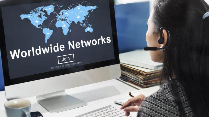 A woman is sitting at a computer with the words "Worldwide Networks" written on the screen. She's weighing Usenet vs Web and deciding which to use today.